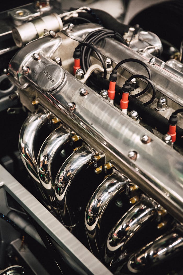 services-04 Detailed view of a polished chrome engine, showcasing luxury automotive design.