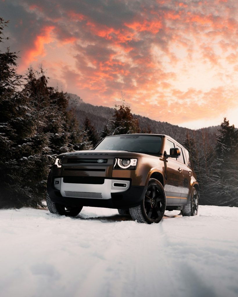 white-suv-on-snow-covered-ground-during-sunset-behxzttlzrm